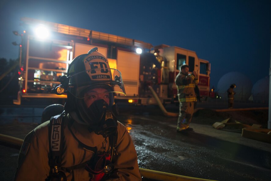 Kenichi Umemura, a 35th Civil Engineer Squadron firefighter, monitors a fire during a controlled burn of at Misawa Air Base, Japan, March 15, 2017. The facility took approximately two hours to burn from the initial ignition to total destruction. It was still actively burning (smoldering) for an additional 12 to 18 hours after. The firefighters trained on their forcible entry techniques and learned more about fire behavior. This was the first time the 35th CES firefighters set fire to a building without the intent to put it out. (U.S. Air Force photo by Staff Sgt. Melanie A. Hutto)