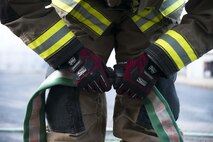 A 35th Civil Engineer Squadron firefighter connects two firehoses prior to a controlled burn of a building at Misawa Air Base, Japan, March 15, 2017. The hoses were placed strategically in front of the building in case the fire got out of control. Firefighters provide programs and services designed to protect the lives and property of the inhabitants and visitors of Misawa AB. They train to meet both local and global missions. (U.S. Air Force photo by Staff Sgt. Melanie A. Hutto)