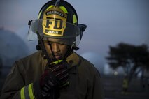 Airman 1st Class James Butler, a 35th Civil Engineer Squadron firefighter, talks into a radio prior to a controlled burn of a condemned building at Misawa Air Base, Japan, March 15, 2017. Fire Protection specialists deal with everything from brush fires to burning rocket fuel and hazardous material fires. Firefighters uphold the 35th Fighter Wing mission by ensuring the safety of the pilots and the bases populace. (U.S. Air Force photo by Staff Sgt. Melanie A. Hutto)