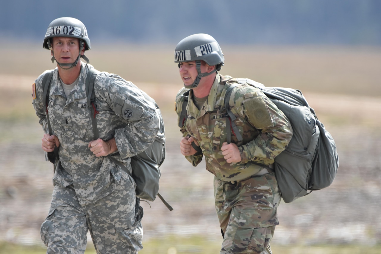 Army Reserve 1st Lt. Nicholas T. Krantz, commander of the 811th Ordnance Company, 321st Ordnance Battalion, 38th Regional Support Group, 310th Sustainment Command (Expeditionary), headquartered in Rainelle, W. Va., left, conducts airborne operations training at Fryar Drop Zone, Ft. Benning, Ga., Feb. 20, 2016.