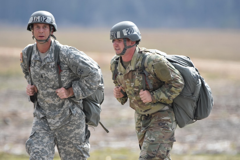Army Reserve 1st Lt. Nicholas T. Krantz, commander of the 811th Ordnance Company, 321st Ordnance Battalion, 38th Regional Support Group, 310th Sustainment Command (Expeditionary), headquartered in Rainelle, W. Va., left, conducts airborne operations training at Fryar Drop Zone, Ft. Benning, Ga., Feb. 20, 2016.