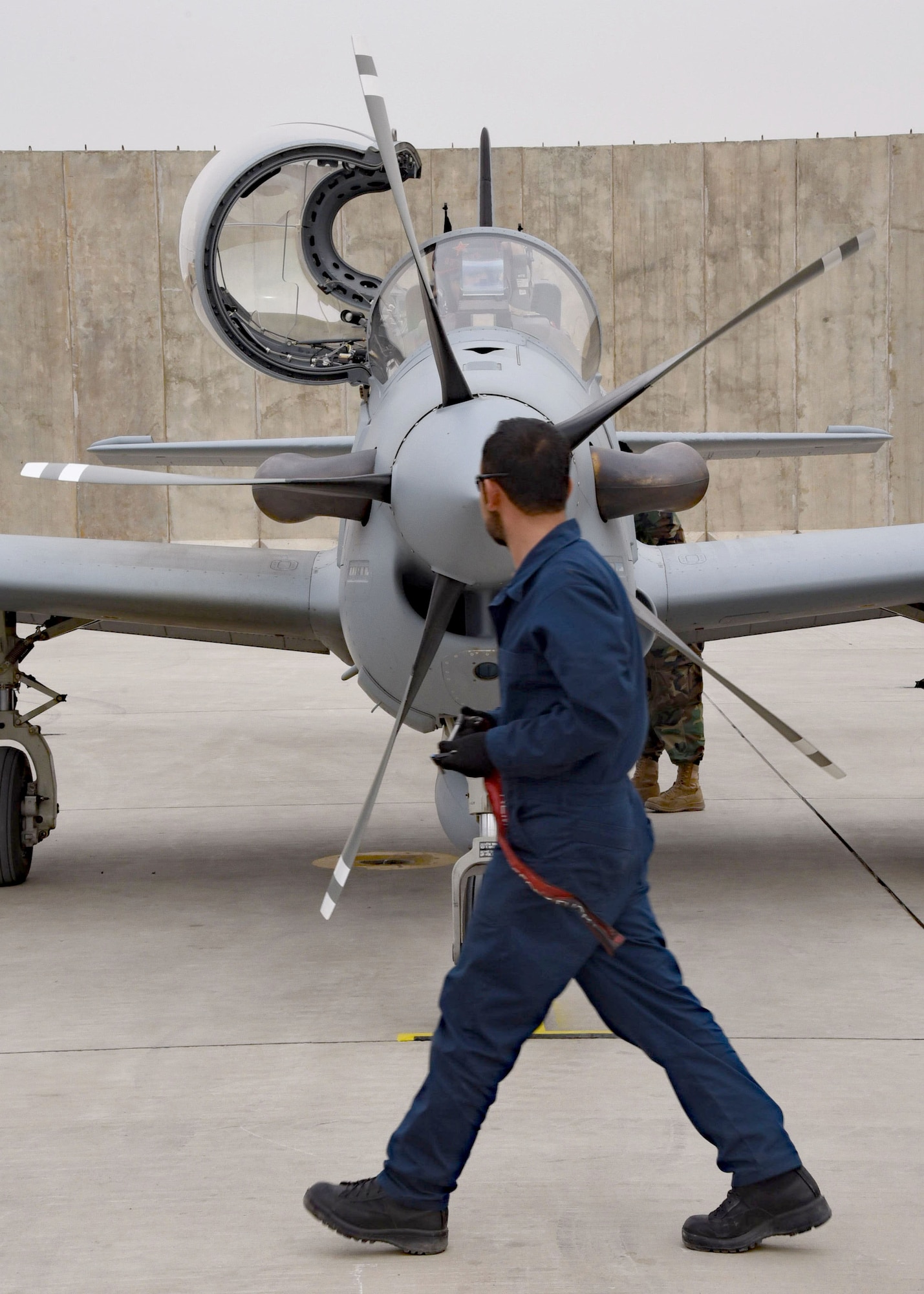 An Afghan Air Force crew chief inspects one of four A-29 Super Tucano light-attack aircraft arriving for duty at Kabul Air Wing, Kabul, Afghanistan, March 20, 2017. The A-29s will be used by the Afghan Air Force for close-air attack, air interdiction, escort and armed reconnaissance. These latest arrivals, which traveled from Moody Air Force Base, Ga., bring the AAF A-29 inventory from eight to 12 aircraft in country. (U.S. Air Force photo by Tech. Sgt. Veronica Pierce)