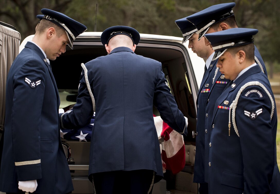 An Honor Guard pall bearer lifts the American flag to begin to remove a casket from a hearse during the unit’s graduation ceremony at Eglin Air Force Base, Fla., March 1.  Approximately 12 new Airmen graduated from the 120-plus-hour course. The graduation performance includes flag detail, rifle volley, pall bearers and bugler for friends, family and unit commanders. (U.S. Air Force photo/Samuel King Jr.)