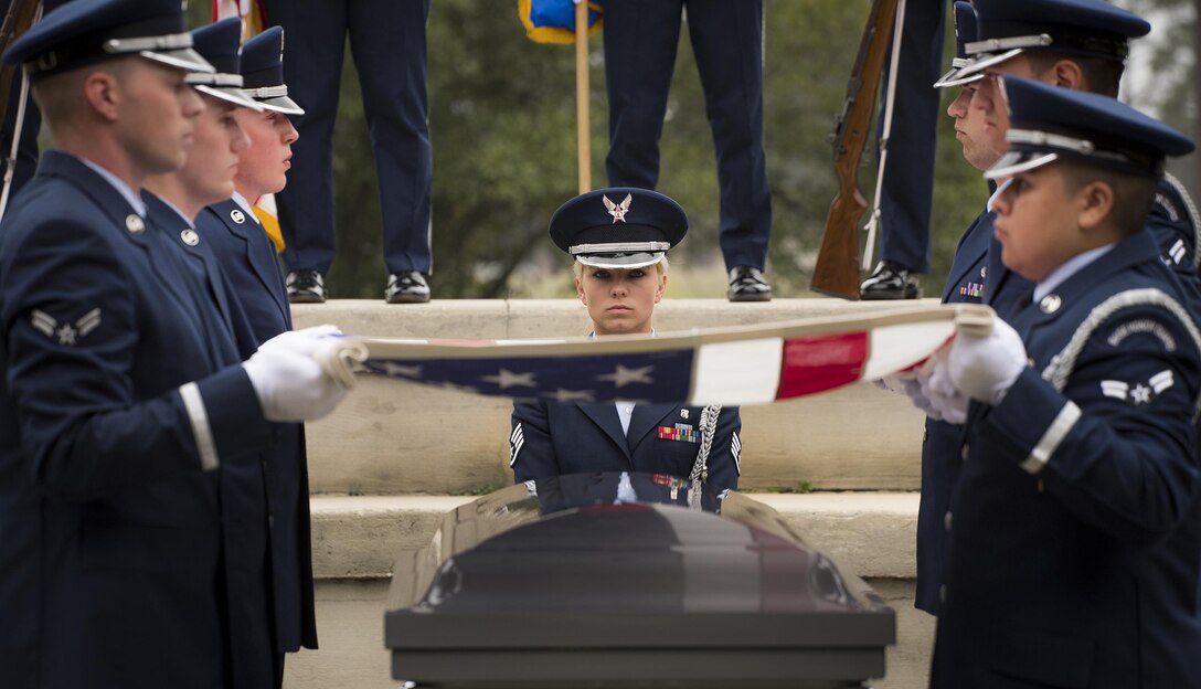 Staff Sgt. Elena Konter, 96th Medical Operations Squadron, stands at attention during the flag-folding portion of the unit’s graduation ceremony at Eglin Air Force Base, Fla., March 1.  Approximately 12 new Airmen graduated from the 120-plus-hour course. The graduation performance includes flag detail, rifle volley, pall bearers and bugler for friends, family and unit commanders. (U.S. Air Force photo/Samuel King Jr.)