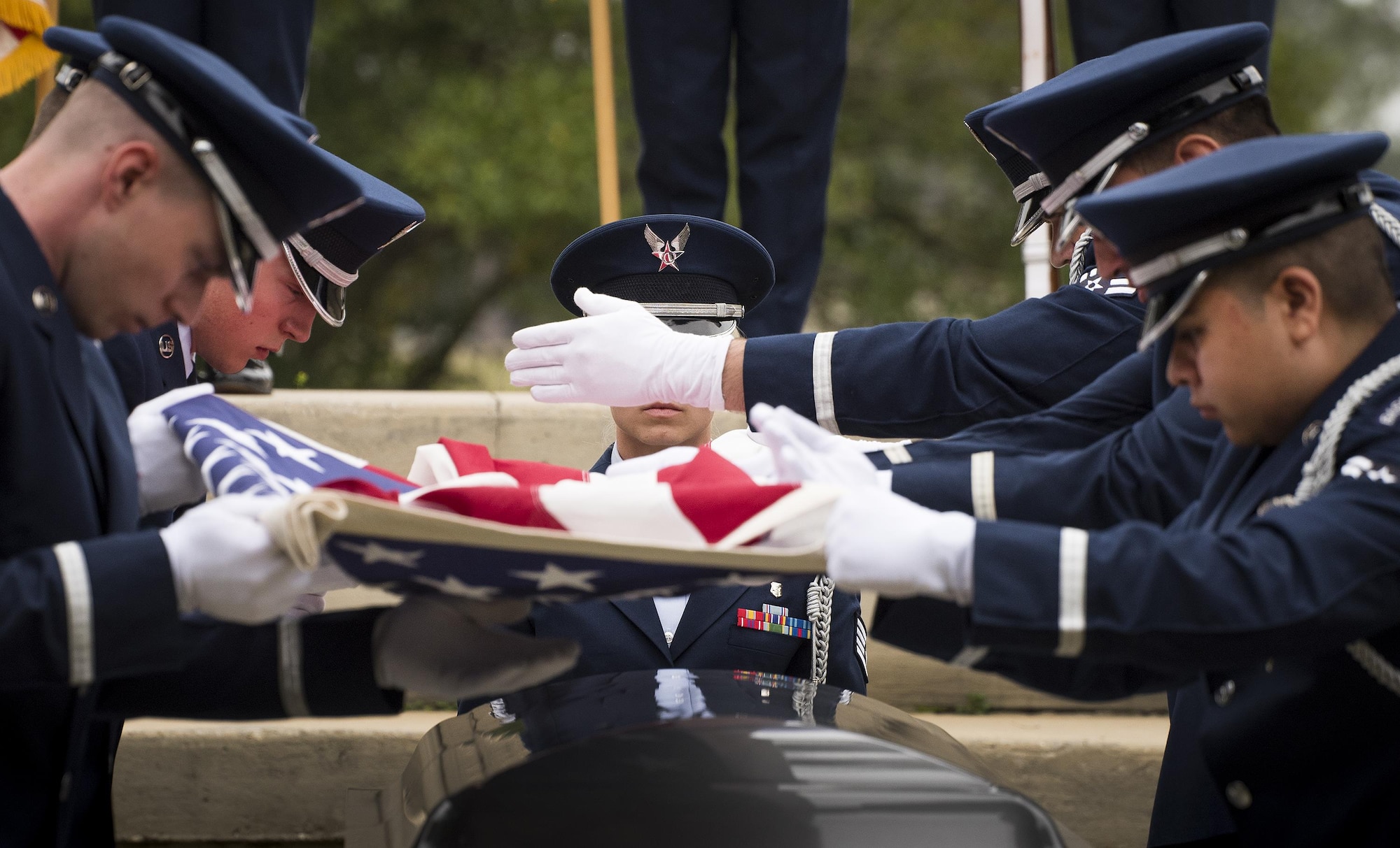 An Honor Guard Airman begins to make the first folds of the flag-folding portion at the unit’s graduation ceremony at Eglin Air Force Base, Fla., March 1.  Approximately 12 new Airmen graduated from the 120-plus-hour course. The graduation performance includes flag detail, rifle volley, pall bearers and bugler for friends, family and unit commanders. (U.S. Air Force photo/Samuel King Jr.)