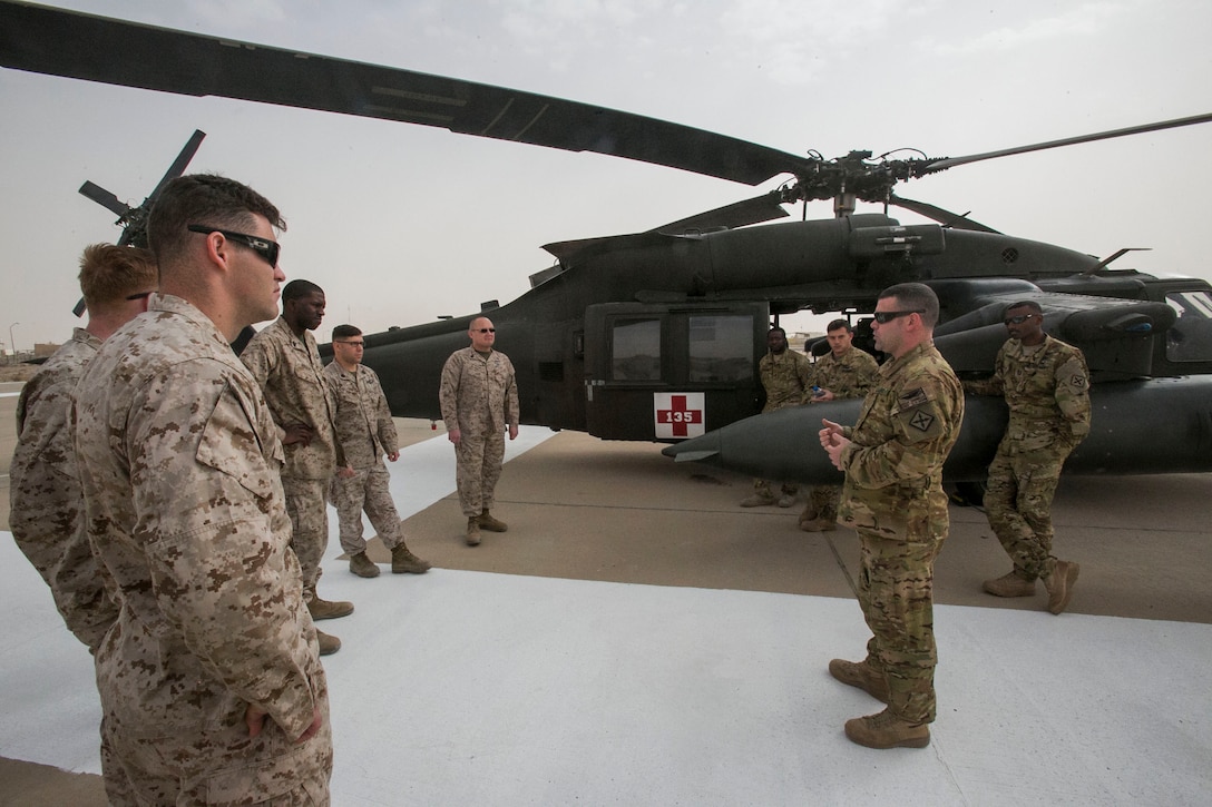 U.S. Army Chief Warrant Officer Kevin Connolly, an HH-60M Black Hawk helicopter pilot with Charlie Company, 1-111th Aviation Regiment, briefs U.S. Navy corpsmen with Special Purpose Marine Air-Ground Task Force-Crisis Response-Central Command before conducting a joint dustoff training event while forward deployed in the Middle East, Jan. 28, 2017. Dustoff training consists of the rapid loading and unloading of casualties into and out of the Black Hawk helicopter; being able to quickly and efficiently treat wounded personnel on the move with joint forces supports the SPMAGTF’s vast crisis response capability. (U.S. Marine Corps photo by Lance Cpl. Kyle McNan)