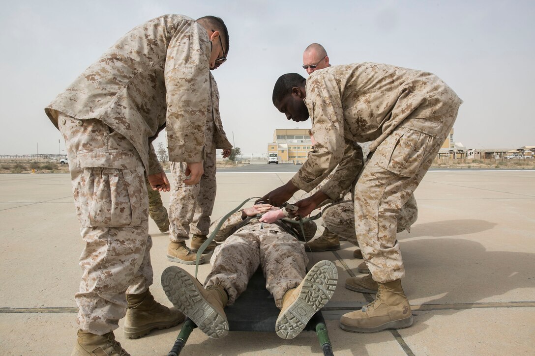 U.S. Navy corpsmen with Special Purpose Marine Air-Ground Task Force-Crisis Response-Central Command strap a simulated casualty to a stretcher during a joint dustoff training event while forward deployed in the Middle East, Jan. 28, 2017. Being able to quickly and efficiently treat wounded personnel on the move with joint forces supports the SPMAGTF’s vast crisis response capability. (U.S. Marine Corps photo by Lance Cpl. Kyle McNan)