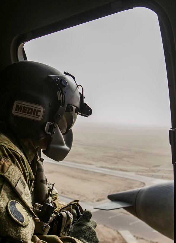 U.S. Army Staff Sgt. Steven Liebl, a critical care flight medic with Charlie Company, 1-111th Aviation Regiment, rides in an HH-60M Black Hawk helicopter during a joint dustoff training event with Special Purpose Marine Air-Ground Task Force-Crisis Response-Central Command while forward deployed in the Middle East, Jan. 28, 2017. Dustoff training consists of the rapid loading and unloading of casualties into and out of the Black Hawk helicopter; being able to quickly and efficiently treat wounded personnel on the move with joint forces supports the SPMAGTF’s vast crisis response capability. (U.S. Marine Corps photo by Lance Cpl. Kyle McNan)