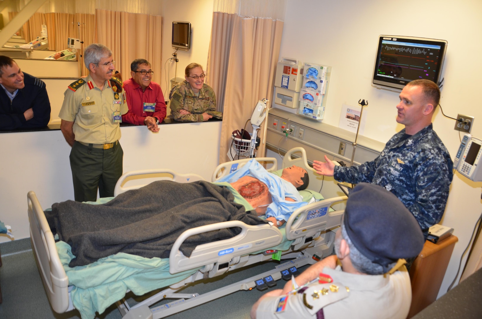 Participants in the CENTCOM Theater Medical Conference tour the Nurse Synthesis Laboratory in the Basic Medical Technician Corpsman program at the Medical Education and Training Campus. In the lab, high-tech human-patient, high-fidelity mannequins are used to train Navy and Air Force students to evaluate and assess “patients”, and apply the skills they have learned to provide appropriate care. Medical professionals representing more than 10 countries within the US Central Command area of operation, Europe, and the U.S. attended the conference to aid in the continued development of capabilities that will serve to improve regional interoperability and cooperation. (Medical Education and Training Campus Public Affairs photo by Lisa Braun/Released)