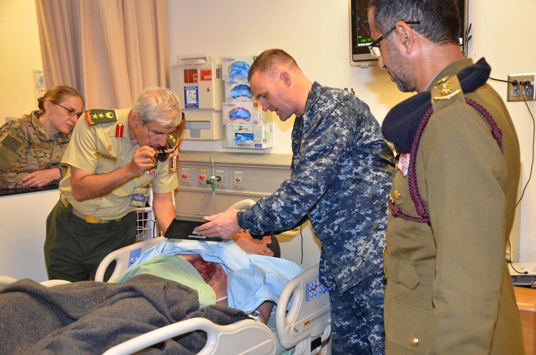 Participants in the CENTCOM Theater Medical Conference tour the Nurse Synthesis Laboratory in the Basic Medical Technician Corpsman program at the Medical Education and Training Campus. In the lab, high-tech human-patient, high-fidelity mannequins are used to train Navy and Air Force students to evaluate and assess “patients”, and apply the skills they have learned to provide appropriate care. Medical professionals representing more than 10 countries within the US Central Command area of operation, Europe, and the U.S. attended the conference to aid in the continued development of capabilities that will serve to improve regional interoperability and cooperation. (Medical Education and Training Campus Public Affairs photo by Lisa Braun/Released)