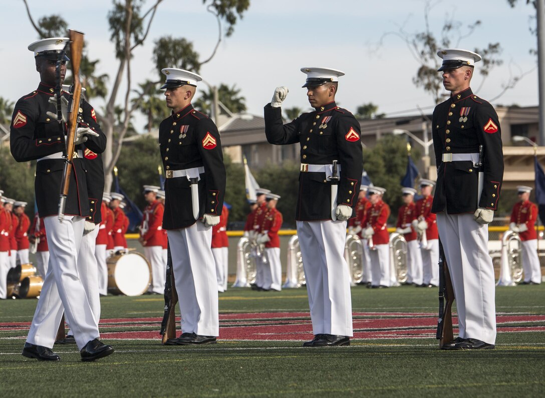 Corporal Jesse Thorton, number two rifle inspector, Marine Corps Silent Drill Platoon executes a rifle inspection during a ceremony as a part of the U.S. Marine Corps Battle Color Detachment (BCD) performance tour aboard Marine Corps Air Station Miramar, Miramar, Ca., Mar. 10, 2017. The BCD is comprised of the Marine Corps Silent Drill Platoon, “The Commandant’s Own,” the United States Marine Drum & Bugle Corps and the Marine Corps Color Guard. The Marines of this highly skilled unit travel across the country to demonstrate the discipline, professionalism, and “Esprit de Corps” of United States Marines. (Official Marine Corps photo by Cpl. Robert Knapp/Released)