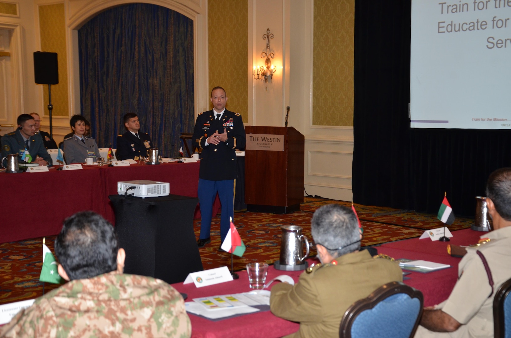 Col. Jack Davis, commandant of the Medical Education and Training Campus, presents a brief to participants in the U.S. Central Command Theater Medical Conference held at the Westin Riverwalk in San Antonio. Davis, a family nurse practitioner in the U.S. Army Nurse Corp, spoke about the tri-Service, enlisted medical training campus for Army, Navy, and Air Force students and answered questions. Medical professionals representing more than 10 countries within the US Central Command area of operation, Europe, and the U.S. attended the conference to aid in the continued development of capabilities that will serve to improve regional interoperability and cooperation. (Medical Education and Training Campus Public Affairs photo by Lisa Braun/Released)