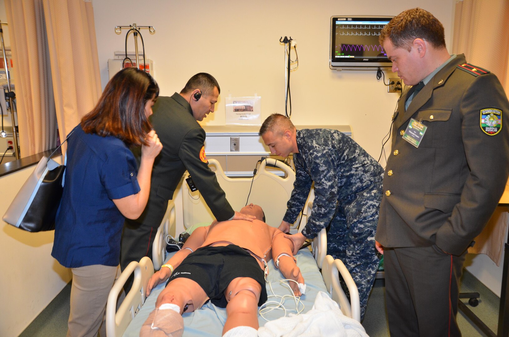 Participants in the CENTCOM Theater Medical Conference tour the Nurse Synthesis Laboratory in the Basic Medical Technician Corpsman program at the Medical Education and Training Campus. In the lab, high-tech human-patient, high-fidelity mannequins are used to train Navy and Air Force students to evaluate and assess “patients”, and apply the skills they have learned to provide appropriate care.  Medical professionals representing more than 10 countries within the US Central Command area of operation, Europe, and the U.S. attended the conference to aid in the continued development of capabilities that will serve to improve regional interoperability and cooperation. (Medical Education and Training Campus Public Affairs photo by Lisa Braun/Released)