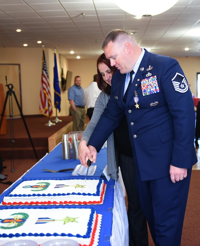 Retired U.S. Air Force Master Sgt. Kristopher Parker, an explosive disposal technician, and wife Zuzanna, cut Parker’s Silver Star cake after his ceremony March 17, 2017, at Dyess Air Force Base, Texas. Parker distinguished himself by bravery and devotion to duty in connection with military operations against an armed enemy of the United States as an EOD team leader. (U.S. Air Force photo by Airman 1st Class Emily Copeland)