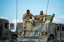 Senior Airman Francky Desravines, 105th Base Defense Squadron fireteam member, left, eats lunch with Senior Airman Jared Dublin, 822d Base Defense Squadron fireteam member, during a Mission Readiness Exercise, March 8, 2017, at Avon Park Air Force Range, Fla. Airmen from the 105th BDS embedded into the 822d BDS to participate in the exercise. While the 822d BDS used the exercise to validate their training and regain their status as a Global Response Force, the 105th BDS received training that allowed them to show their capabilities and strengthened the bond between the two squadrons. (U.S. Air Force Photo by Airman 1st Class Janiqua P. Robinson)