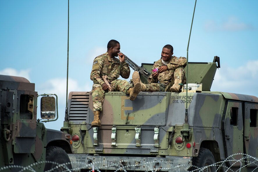 Senior Airman Francky Desravines, 105th Base Defense Squadron fireteam member, left, eats lunch with Senior Airman Jared Dublin, 822d Base Defense Squadron fireteam member, during a Mission Readiness Exercise, March 8, 2017, at Avon Park Air Force Range, Fla. Airmen from the 105th BDS embedded into the 822d BDS to participate in the exercise. While the 822d BDS used the exercise to validate their training and regain their status as a Global Response Force, the 105th BDS received training that allowed them to show their capabilities and strengthened the bond between the two squadrons. (U.S. Air Force Photo by Airman 1st Class Janiqua P. Robinson)
