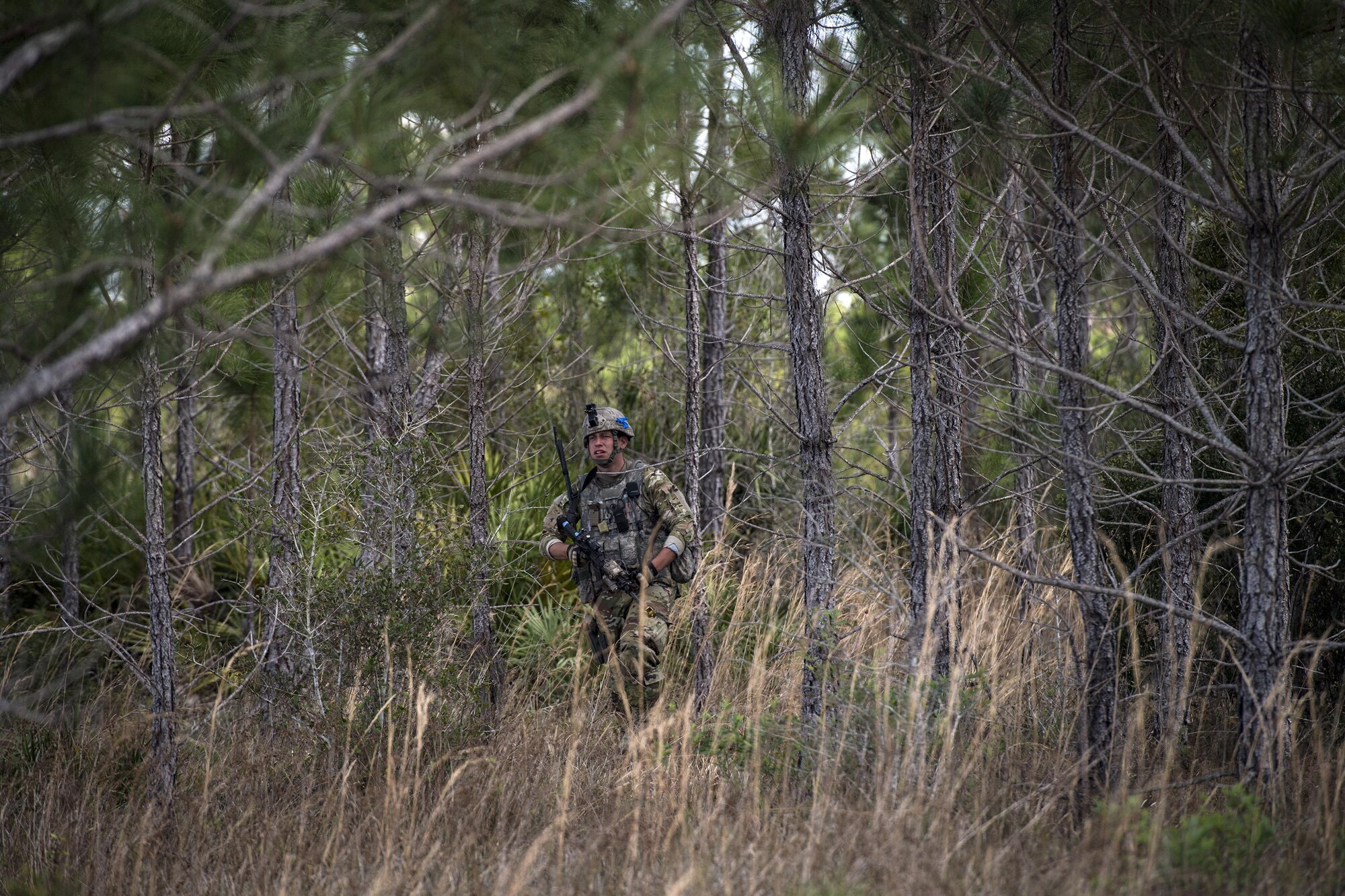Staff Sgt. Christopher Imel, 822d Base Defense Squadron fireteam leader, patrols an area in response to reports of suspicious activity during a Mission Readiness Exercise, March 9, 2017, at Avon Park Air Force Range, Fla. The MRX took place March 2-13 and ensured the 822d BDS could efficiently deploy anywhere in the world in less than 72 hours. During the two week MRX, the squadron was evaluated on its ability to set-up a bare base, effectively thwart enemy attacks, run a secure Tactical Operation Center and maintain positive relationships with villagers in surrounding areas. (U.S. Air Force Photo by Airman 1st Class Janiqua P. Robinson)