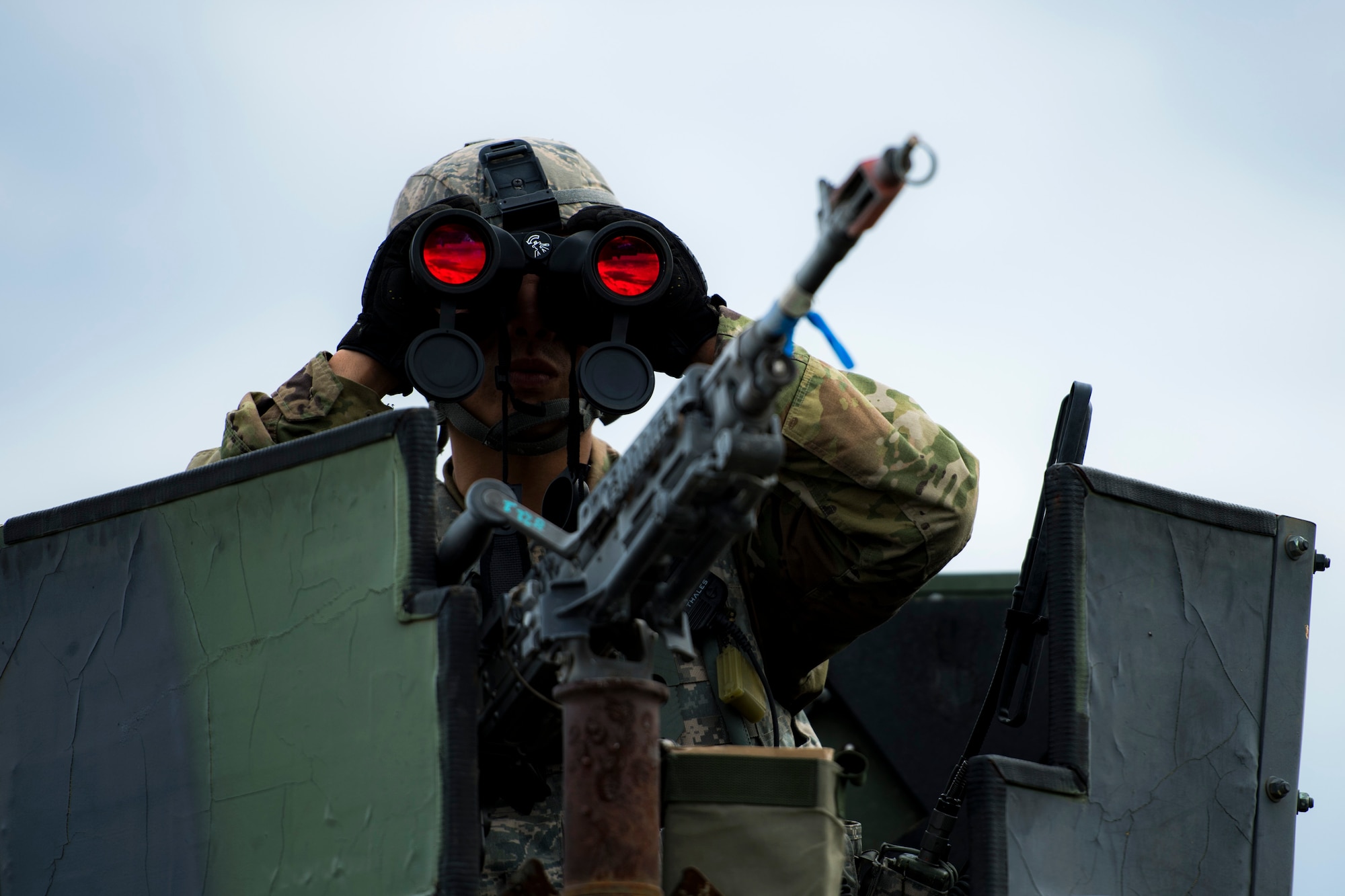 Airman 1st Class Chun Ko, 105th Base Defense Squadron fireteam member, looks into a nearby village to ensure there are no hostile villagers preparing to ambush is team during a Mission Readiness Exercise, March 8, 2017, at Avon Park Air Force Range, Fla. Airmen from the 105th BDS embedded into the 822d Base Defense Squadron to participate in the exercise. While the 822d BDS used the exercise to validate their training and regain their status as a Global Response Force, the 105th BDS received training that allowed them to show their capabilities and strengthened the bond between the two squadrons. (U.S. Air Force Photo by Airman 1st Class Janiqua P. Robinson)