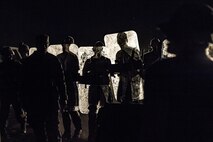 Airmen don riot gear and equipment in response to a simulated protest by locals living in a nearby village during a Mission Readiness exercise, March 8, 2017, at Avon Park Air Force Range, Fla. Airmen from the 105th Base Defense Squadron embedded into the 822d Base Defense Squadron to participate in the exercise. While the 822d BDS used the exercise to validate their training and regain their status as a Global Response Force, the 105th BDS received training that allowed them to show their capabilities and strengthened the bond between the two squadrons. (U.S. Air Force Photo by Airman 1st Class Janiqua P. Robinson)