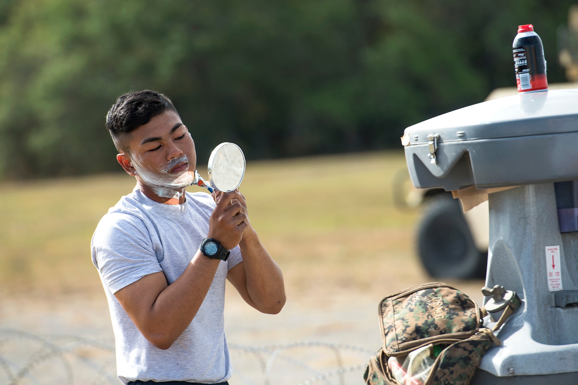 Airman Meynard Guillermo, 822d Base Defense Squadron fireteam member, shaves during a Mission Readiness Exercise, March 8, 2017, at Avon Park Air Force Range, Fla. The MRX took place March 2-13 and ensured the 822d BDS could efficiently deploy anywhere in the world in less than 72 hours. During the two week MRX, the squadron was evaluated on its ability to set-up a bare base, effectively thwart enemy attacks, run a secure Tactical Operation Center and maintain positive relationships with villagers in surrounding areas. (U.S. Air Force Photo by Airman 1st Class Janiqua P. Robinson)