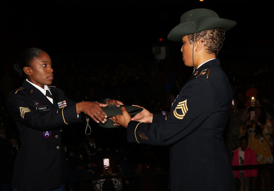 Army Reserve Sgt. Earlandrius C. Parker, a Canton, Ohio resident and a drill sergeant with the 108th Training Command (IET),  takes her drill sergeant hat from senior drill sergeant leader Sgt. 1st Class Tanya Polk, during a graduation ceremony at Fort Jackson, S.C. March 8, 2017. (U.S. Army Reserve Photo by Maj. Michelle Lunato)