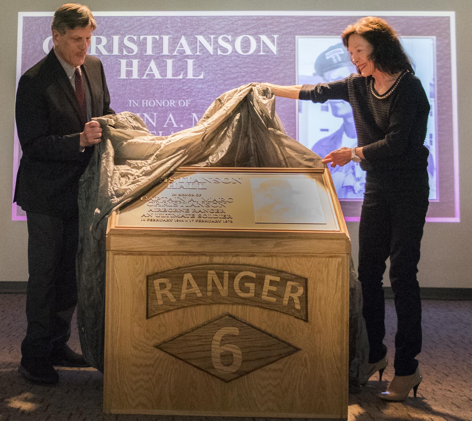 Jim and Dr. Betsy Christianson unveil the plaque for Capt. A. Marc Christianson III during the 6th Ranger Training Battalion’s headquarters building dedication ceremony March 17 at Eglin Air Force Base, Fla.  The building was dedicated to Christianson, who passed away on the training range in 1972.  (U.S. Air Force photo/Samuel King Jr.)