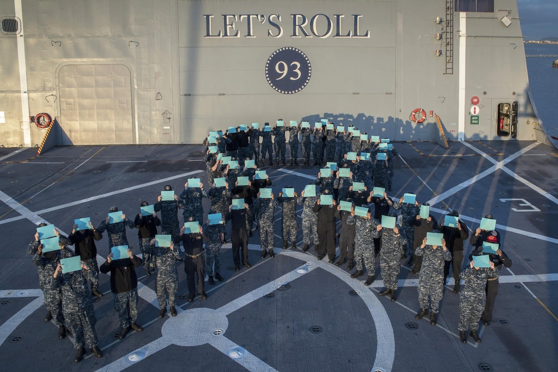 Sailors form a human ribbon.