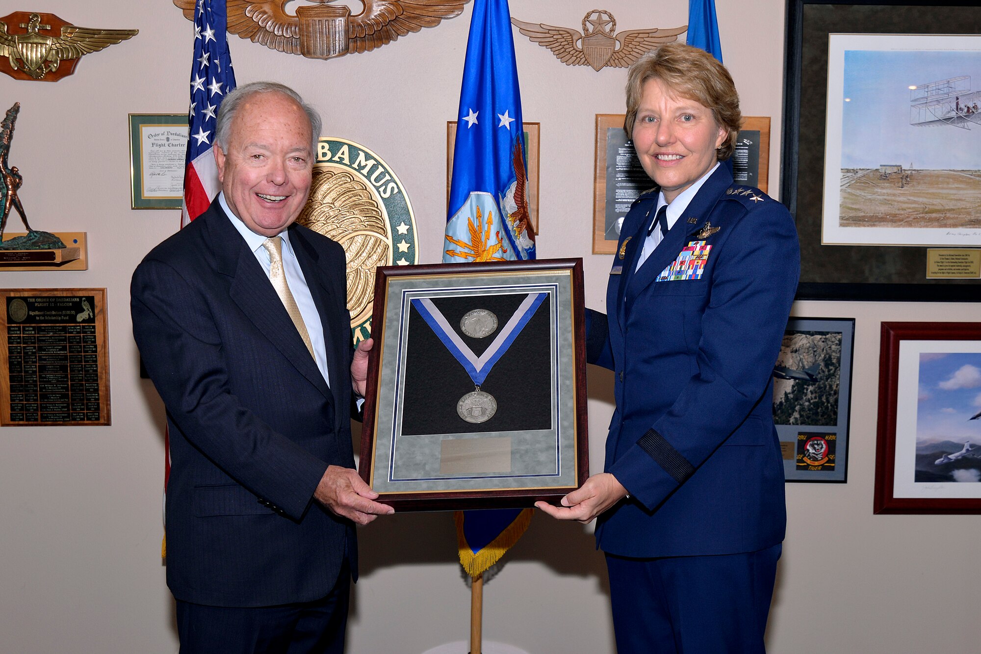 Bill Hybl, the chairman of the Air Force Academy Foundation, accepts the 2015 Distinguished Service Award on behalf of the foundation, from Lt. Gen. Michelle Johnson, the superintendent of the U.S. Air Force Academy. (U.S. Air Force photo)