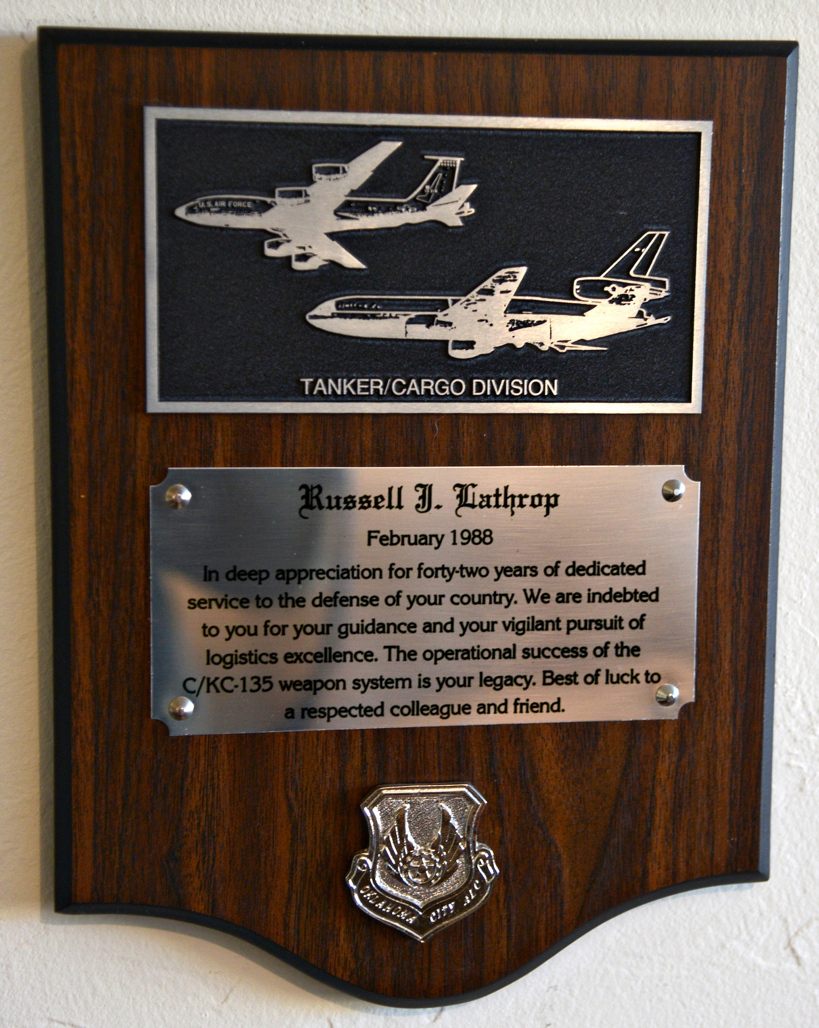 A plaque gifted to him at his retirement ceremony in 1988, and his most valued possession, reads, “The operational success of the C/KC-135 weapon system is your legacy.” (Air Force photo by Kelly White)