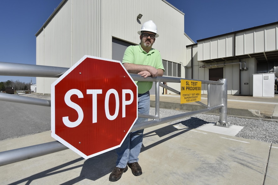 Bernie Williamson, AEDC test operations engineer, operates a barricade located at the AEDC Sea Level Engine Test Facility. This new barricade was installed to replace a temporary barricade as part of a Safety Condition Campaign focusing on barricades and signs. (U.S. Air Force photo/Rick Goodfriend)
