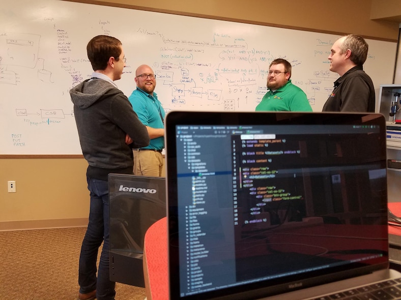 AFRL researcher Matt Jacobsen (second from left), developer of the Hyperthought data management and sharing software, strategizes with team members Kevin Porter, James Fourman, and Jason Thiese during a recent collaboration session at the AFRL Maker Hub. (U.S. Air Force photo/Holly Jordan)