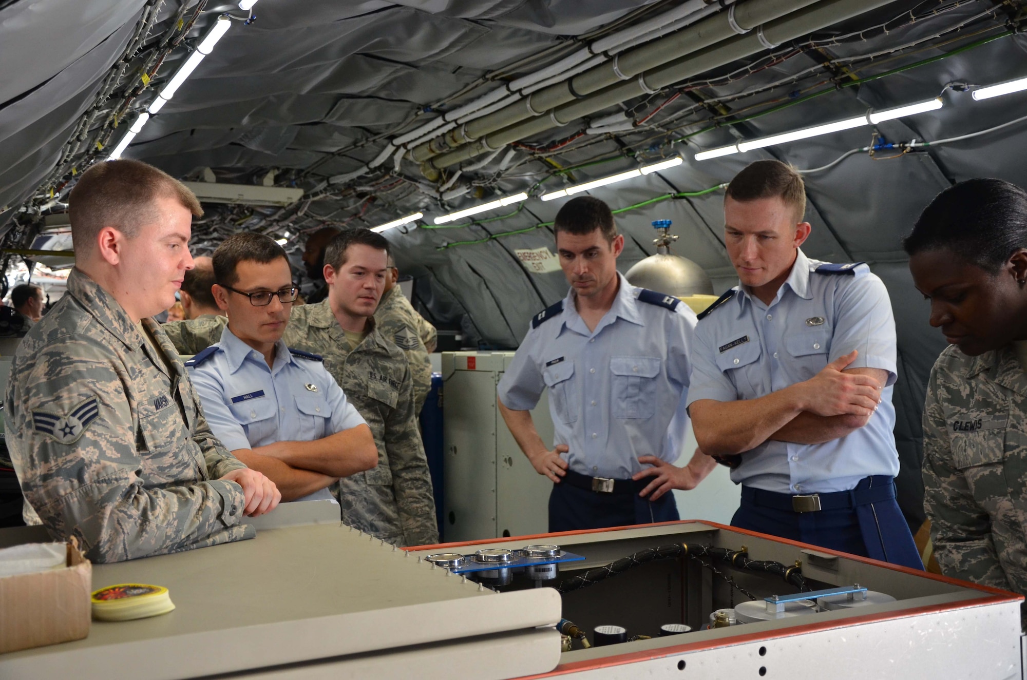 Senior Airman Tristan Marsh (left), briefs a group of visitors on the capabilities of the WC-135 Constant Phoenix Feb. 14, 2017.  The jet was on display at Patrick AFB, Fla., for members of the Air Force Technical Applications Center and the 45th Space Wing.  As people made their way through and around the aircraft, crewmembers discussed the features and capabilities of the atmospheric collection suite, which allows the mission crew to detect radioactive ‘clouds’ in real time. (U.S. Air Force photo by Susan A. Romano)