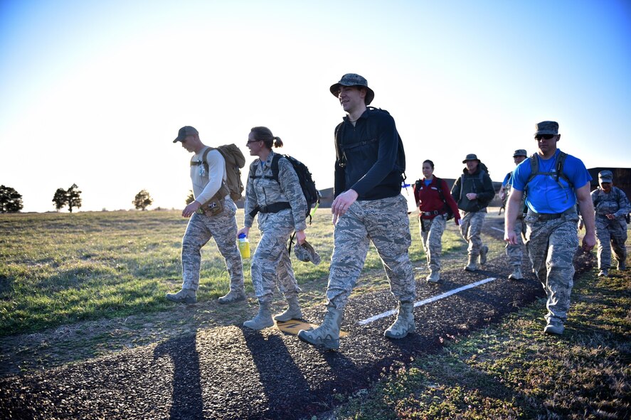 Members of the 932nd Airlift Wing walk the Scott Air Force Base perimeter track, March 3, 2017, in preparation for the Bataan Memorial Death March, held at the White Sands Missile Range in New Mexico.  The march honors the approximately 10,000 men that died during the 65 miles to confinement camps throughout the Philippines.  April 9, 2017 marks the 75th anniversary of the Bataan Death March. (U.S. Air Force photo by Tech. Sgt. Christopher Parr)