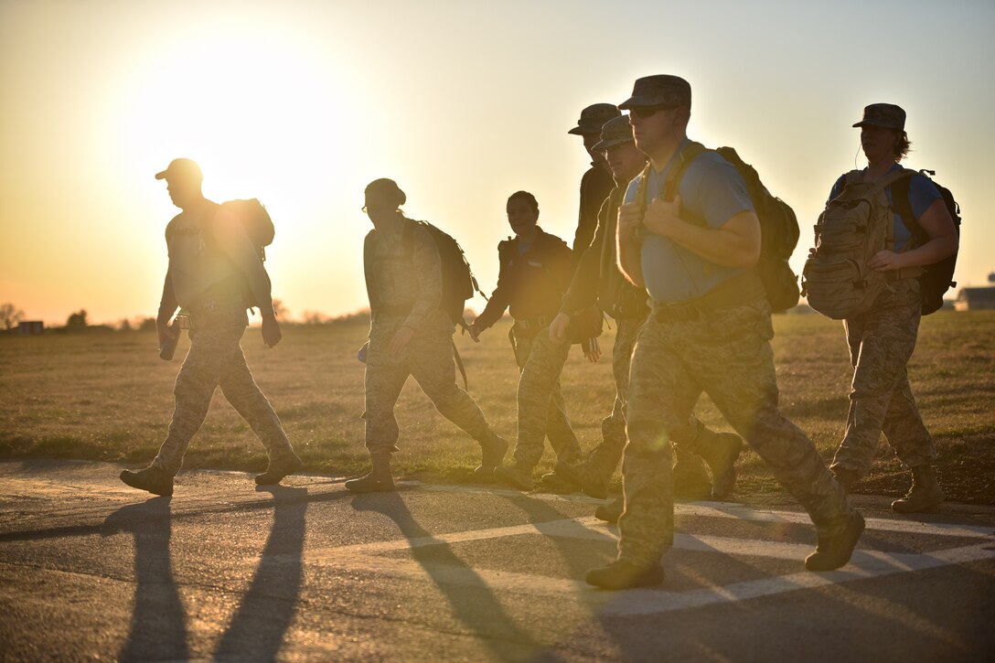 Members of the 932nd Airlift Wing walk the Scott Air Force Base perimeter track, March 3, 2017, in preparation for the Bataan Memorial Death March, held at the White Sands Missile Range in New Mexico.  The march honors the approximately 10,000 men that died during the 65 miles to confinement camps throughout the Philippines.  April 9, 2017 marks the 75th anniversary of the Bataan Death March. (U.S. Air Force photo by Tech. Sgt. Christopher Parr)