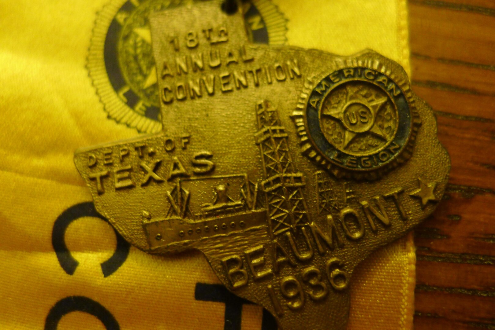 Pin identifying Leon Bell as a member of the reception committee for the 1936 American Legion conference in Beaumont, Texas, where he settled after the war. Medal depicts Spindletop oil well and a Navy ship being built in the local harbor.