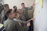 JBSA participants in a Chief of Staff of the Air Force focus group on revitalizing squadrons rearrange sticky notes of ideas to improve squadron level activities at Joint Base San Antonio-Randolph Mar. 16, 2017. Focus groups are being held at 23 bases across the Air Force throughout 2017 to support the initiative. (U.S. Air Force Photo by Sean M. Worrell) 