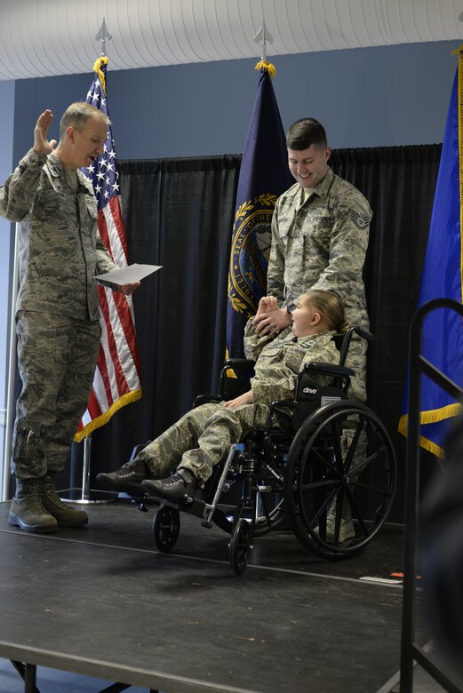 U.S. Air Force Col. James Ryan (left), 157th Air Refueling Wing commander, New Hampshire Air National Guard, recites the oath of enlistment to nine-year-old Ciara Brill, a student at Little Harbour School, with the help of Staff Sgt. Taylor Vondrasek, 157th recruiting member. Ciara was enlisted as an honorary four-star general and member of New Hampshire Air National Guard for the day through the Pease Kids Corps. Pease ANGB N.H. (N.H. Air National Guard photo by Airman Victoria Nelson)