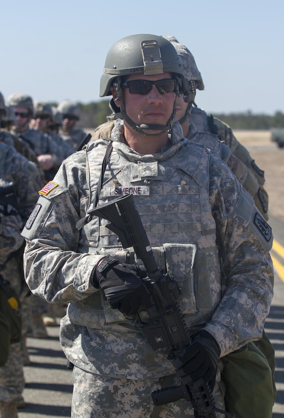 A platoon of military policemen assigned to 340th Military Police Co., 333rd Military Police Brigade, 200th Military Police Command, U.S. Army Reserve, prepare to load onto Light Medium Tactical Vehicles (LMTV) after arriving at Lakehurst Maxfield Field, N.J., Mar 19, 2017, during Warrior Exercise 78-17-01. WAREX 78-17-01 is an important step in building the most capable, combat-ready and lethal force in history. (U.S. Army Reserve photo by Staff Sgt. George F. Gutierrez, 201st Press Camp Headquarters/ Released)