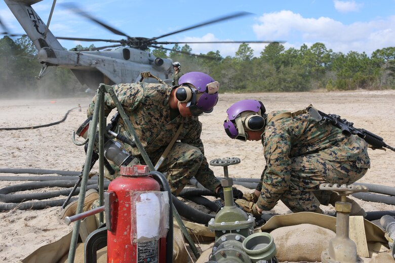 MARINE CORPS AIR STATION CHERRY POINT, N.C.— Lance Cpl. Jacob Wiser, left, and Lance Cpl. Haleigh Reno adjust fuel hoses during Marine Wing Support Squadron 274’s field exercise aboard Marine Corps Outlying Field Atlantic, N.C., March 10, 2017. Marines from MWSS-274, Marine Aircraft Group 29, 2nd Marine Aircraft Wing, established an air facility aboard Marine Corps Auxiliary Landing Field Bogue capable of providing all airfield and air base support functions to MAG-29 squadrons, including a FARP at Atlantic. Wiser and Reno are bulk fuel specialists with MWSS-274. (U.S. Marine Corps photo by Cpl. Jason Jimenez/ Released)