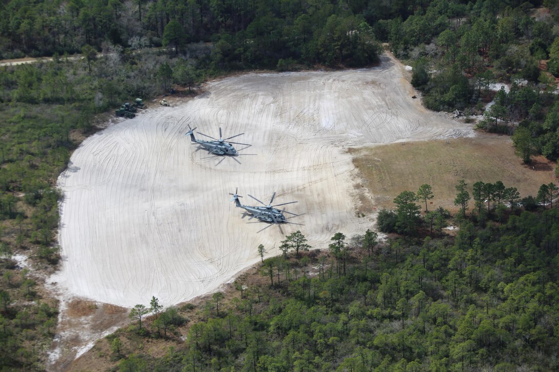 Two CH-53E Super Stallions hold idly during a Tactical Recovery of Aircraft Personnel exercise aboard Marine Corps Outlying Field Atlantic, N.C., March 10, 2017. Marines assigned to Marine Wing Support Squadron 274, Marine Aircraft Group 29, 2nd Marine Aircraft Wing, established an air facility aboard Marine Corps Auxiliary Landing Field Bogue capable of providing all airfield and air base support functions to MAG-29 squadrons, including a FARP at Atlantic. (Marine Corps photo by Cpl. Jason Jimenez/ Released)