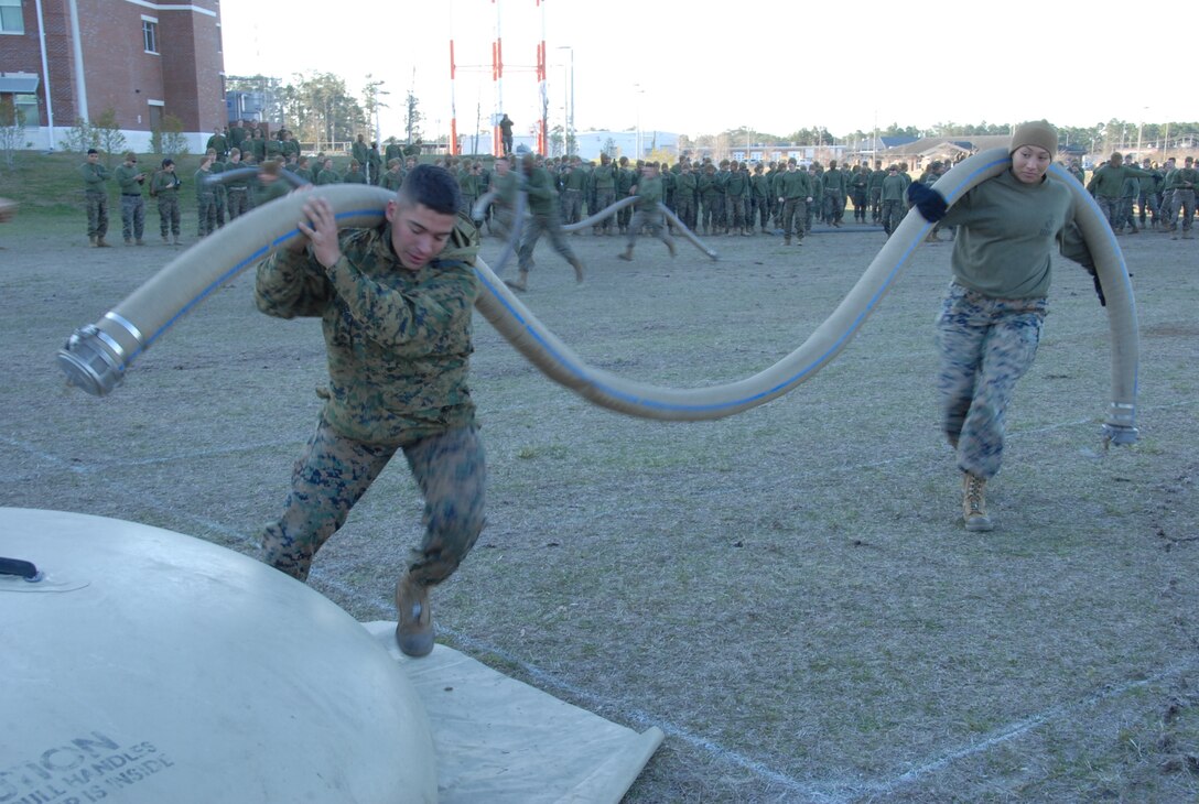On March 16th, 2017 MCES held its annual Engineer Field Meet on Ellis Field. The annual field meet is held to celebrate the patron saint of engineers, St. Patrick; as well as build camaraderie, espirit de corps, and compete for the four-leaf clover trophy. During the Water Hose Relay a team of Marines, broken into two Marine legs; takes turns running a hose approximately 50 meters to a turn-around point and then runs back. Here two Marines have reached the turn around point.
