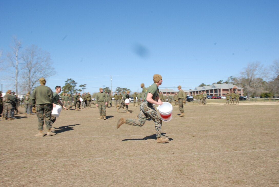 On March 16th, 2017 MCES held its annual Engineer Field Meet on Ellis Field. The annual field meet is held to celebrate the patron saint of engineers, St. Patrick; as well as build camaraderie, espirit de corps, and compete for the four-leaf clover trophy. During the Water Bucket Relay a team of Marines take turns running to a water bladder with a bucket, filling the bucket from the bladder, then running back to the start/finish line to deposit the water into a 50 gallon trash bin.