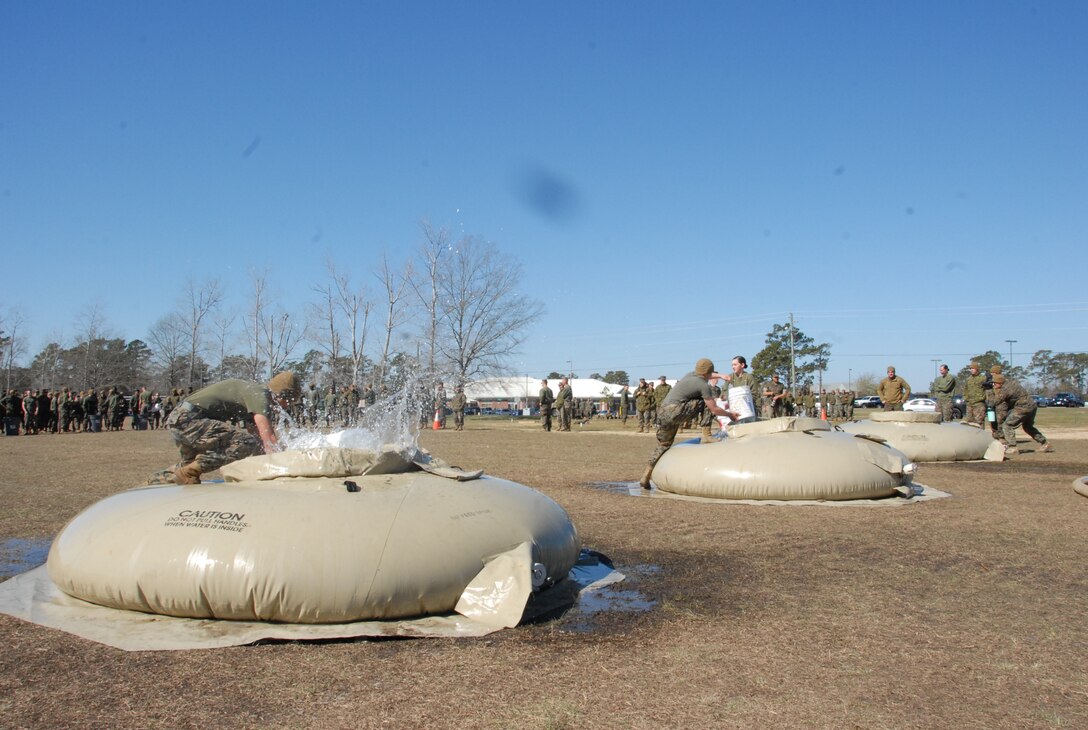 On March 16th, 2017 MCES held its annual Engineer Field Meet on Ellis Field. The annual field meet is held to celebrate the patron saint of engineers, St. Patrick; as well as build camaraderie, espirit de corps, and compete for the four-leaf clover trophy. During the Water Bucket Relay a team of Marines take turns running to a water bladder with a bucket, filling the bucket from the bladder, then running back to the start/finish line to deposit the water into a 50 gallon trash bin.