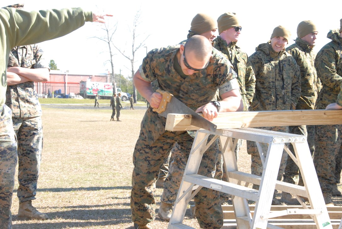 On March 16th, 2017 MCES held its annual Engineer Field Meet on Ellis Field. The annual field meet is held to celebrate the patron saint of engineers, St. Patrick; as well as build camaraderie, espirit de corps, and compete for the four-leaf clover trophy. During the Cross Cut Relay a team of Marines take turns running to station with a saw, 4X4 piece of wood, and eye protection; using the saw to cut a section of wood off the main piece, then run back to the start/finish line.