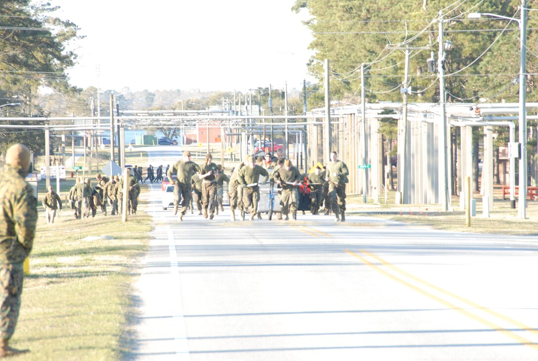 On March 16th, 2017 MCES held its annual Engineer Field Meet on Ellis Field. The annual field meet is held to celebrate the patron saint of engineers, St. Patrick; as well as build camaraderie, espirit de corps, and compete for the four-leaf clover trophy. This year's participants included teams from MCES, MHG, MWSS 272, MWSS 274, 2d CEB, and 8th ESB. Marines competed in 13 engineer themed events that tested strength, stamina, and teamwork. Marines pulling chariots sprint down Monro Street towards the finish line.