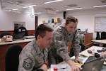 Tech Sgt. Jennifer Schroeder, a Weather Craftsman from the 125th Weather Flight and a native of Tulsa, Okla., and Master Sgt. Seth Huisenga, a Weather Craftsman from the 125th Weather Flight, Oklahoma Air National Guard, and a native of Bixby, Okla., conduct a shift change brief of the Staff Weather Officer station during Allied Spirit VI at the 7th Army Training Command’s Hohenfels Training Area. Allied Spirit VI is a multinational exercise involving 12 nations and over 2,700 troops.