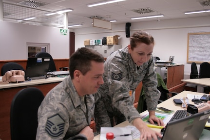 Tech Sgt. Jennifer Schroeder, a Weather Craftsman from the 125th Weather Flight and a native of Tulsa, Okla., and Master Sgt. Seth Huisenga, a Weather Craftsman from the 125th Weather Flight, Oklahoma Air National Guard, and a native of Bixby, Okla., conduct a shift change brief of the Staff Weather Officer station during Allied Spirit VI at the 7th Army Training Command’s Hohenfels Training Area. Allied Spirit VI is a multinational exercise involving 12 nations and over 2,700 troops.