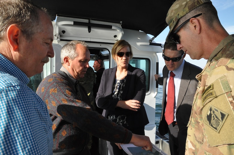 Jim Fields, (2nd from left), the Corps' project manager for the Oceanside Harbor annual maintenance dredging project, describes the project to Col. Peter Helmlinger, the Corps' South Pacific Division commander, during a March 15 boat trip to the project site, as (from left) Paul Lawrence, Oceanside Harbor manager, Deanna Lorson, assistant city manager, and David Van Dorpe, the Los Angeles District's deputy district engineer for programs and project management, look on.