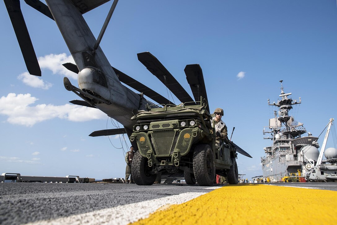 Marine Corps Cpl. Nathan Banta drives a vehicle on the flight deck of the USS Bonhomme Richard to support amphibious integration training in the Philippine Sea, March 15, 2017. The training integrates all elements of the Bonhomme Richard Expeditionary Strike Group and 31st Marine Expeditionary Unit to test their abilities to execute tasks. The Bonhomme Richard is operating in the Indo-Asia-Pacific region to enhance warfighting readiness. Navy photo by Seaman Apprentice Jesse Marquez Magallanes