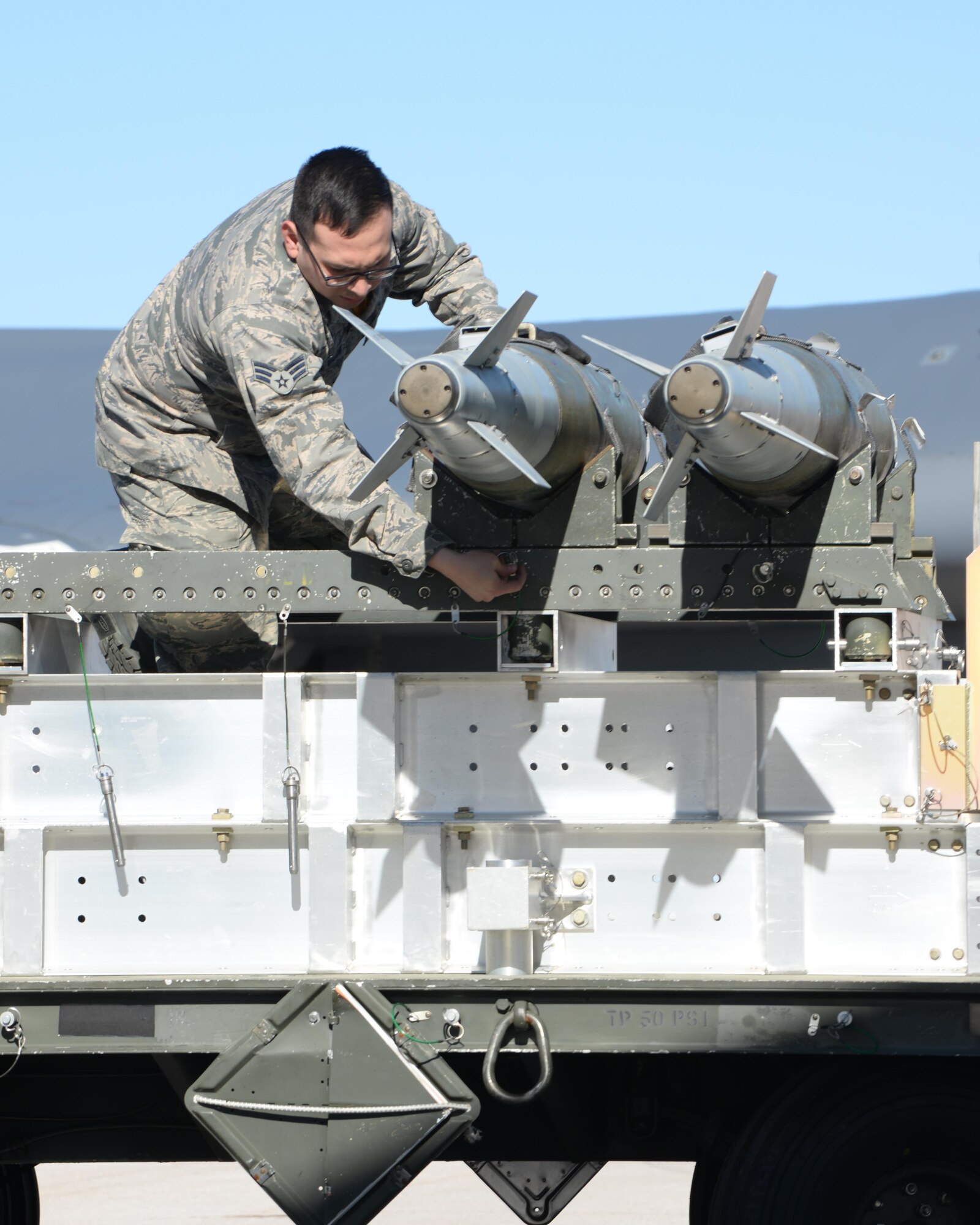 Senior Airman Carlos Del Valle III, a weapons load crew member assigned to the 37th Aircraft Maintenance Unit, retrieves a Mark 82 General Purpose bomb for a load competition at Ellsworth Air Force Base, S.D., March 17, 2017. The loading standardization crew evaluates each competing team on performing safe and reliable weapons loading operations in accordance with B-1 bomber weapons loading technical orders and Air Force instructions. (U.S. Air Force photo by Airman Nicolas Z. Erwin)